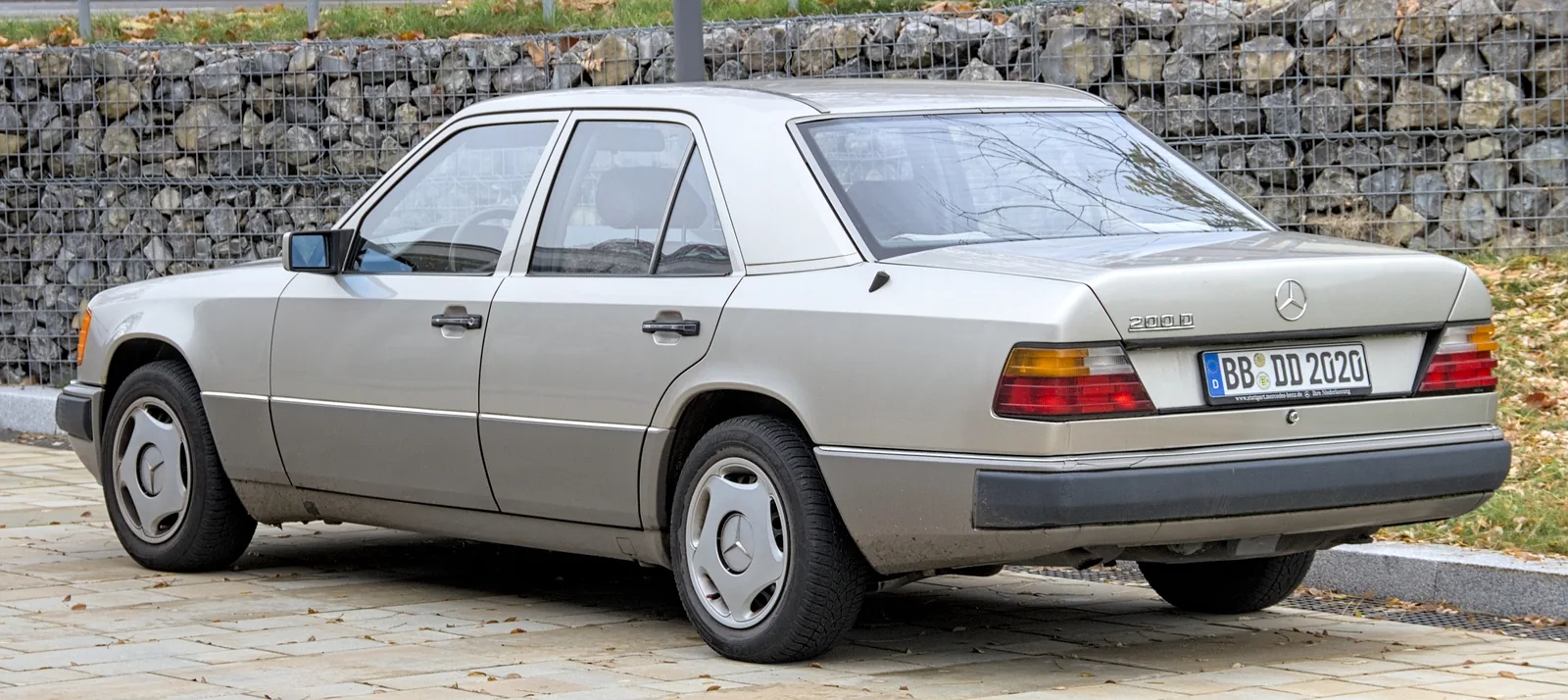 A Mercedes-Benz W124 photographed from the rear three-quarter angle