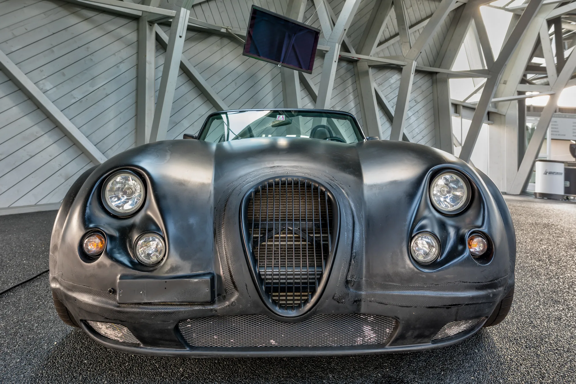A Wiesmann roadster photographed from the front on an open road